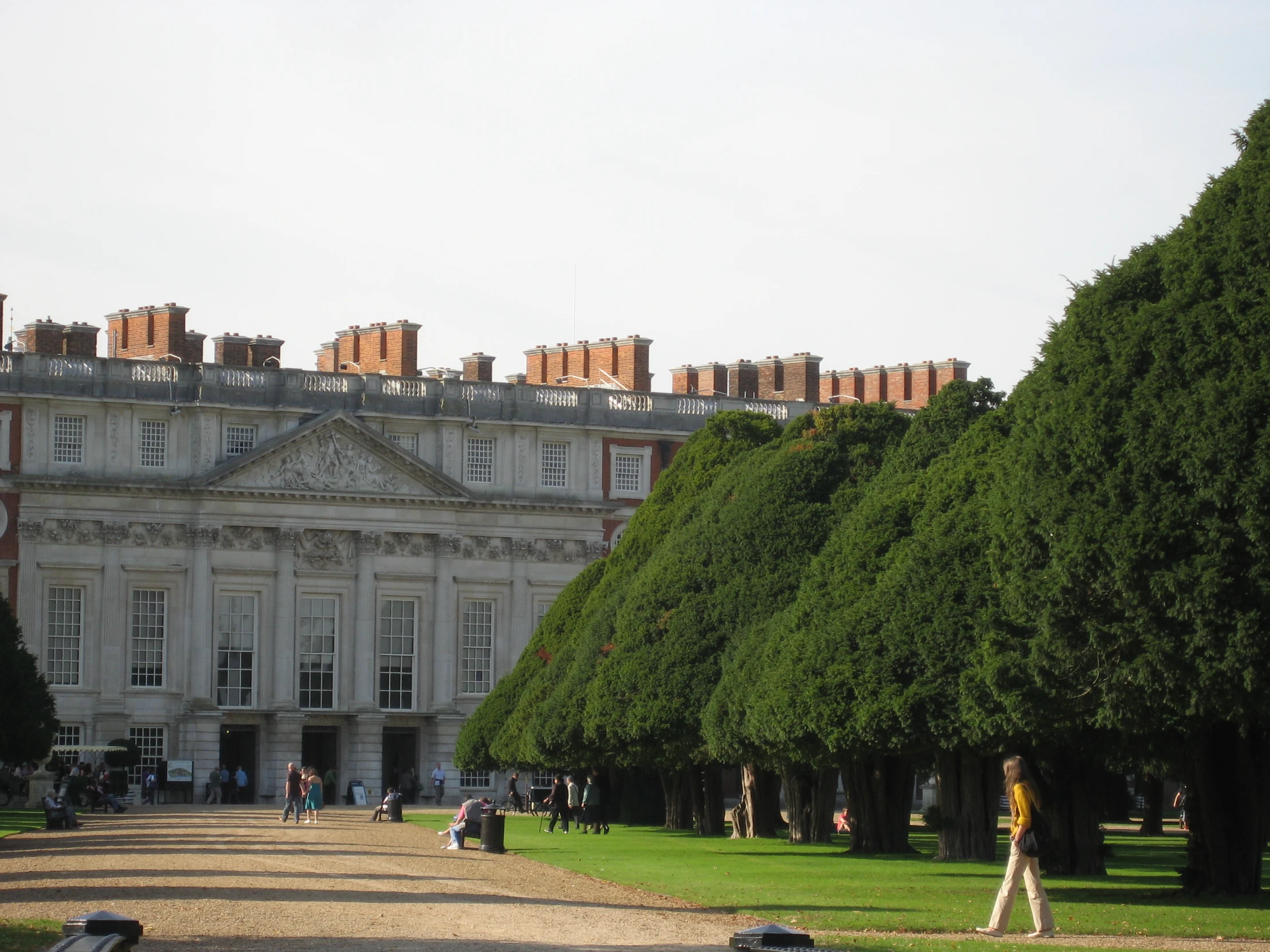 large white building with lots of green trees in front of it