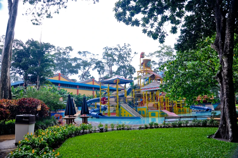 a s play area in the middle of trees and lawn area