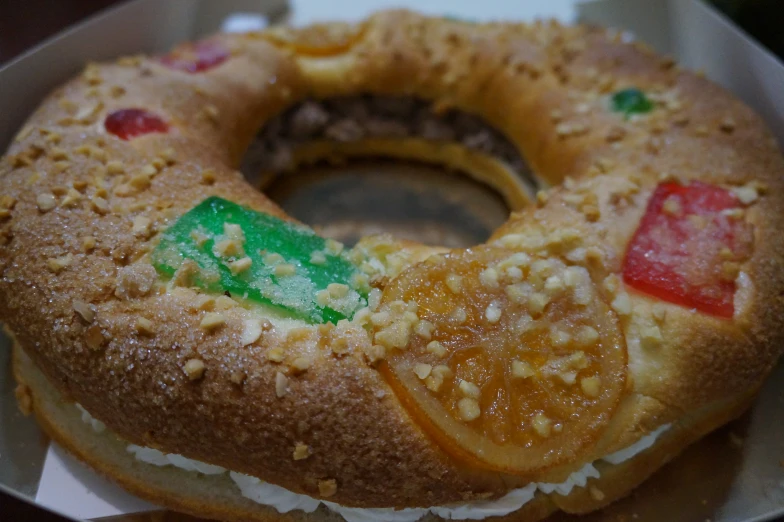 an open donut is adorned with nuts and jello
