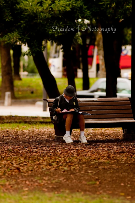 a girl sitting on a bench with a book