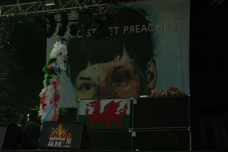 a stage decorated with banners and floral arrangements