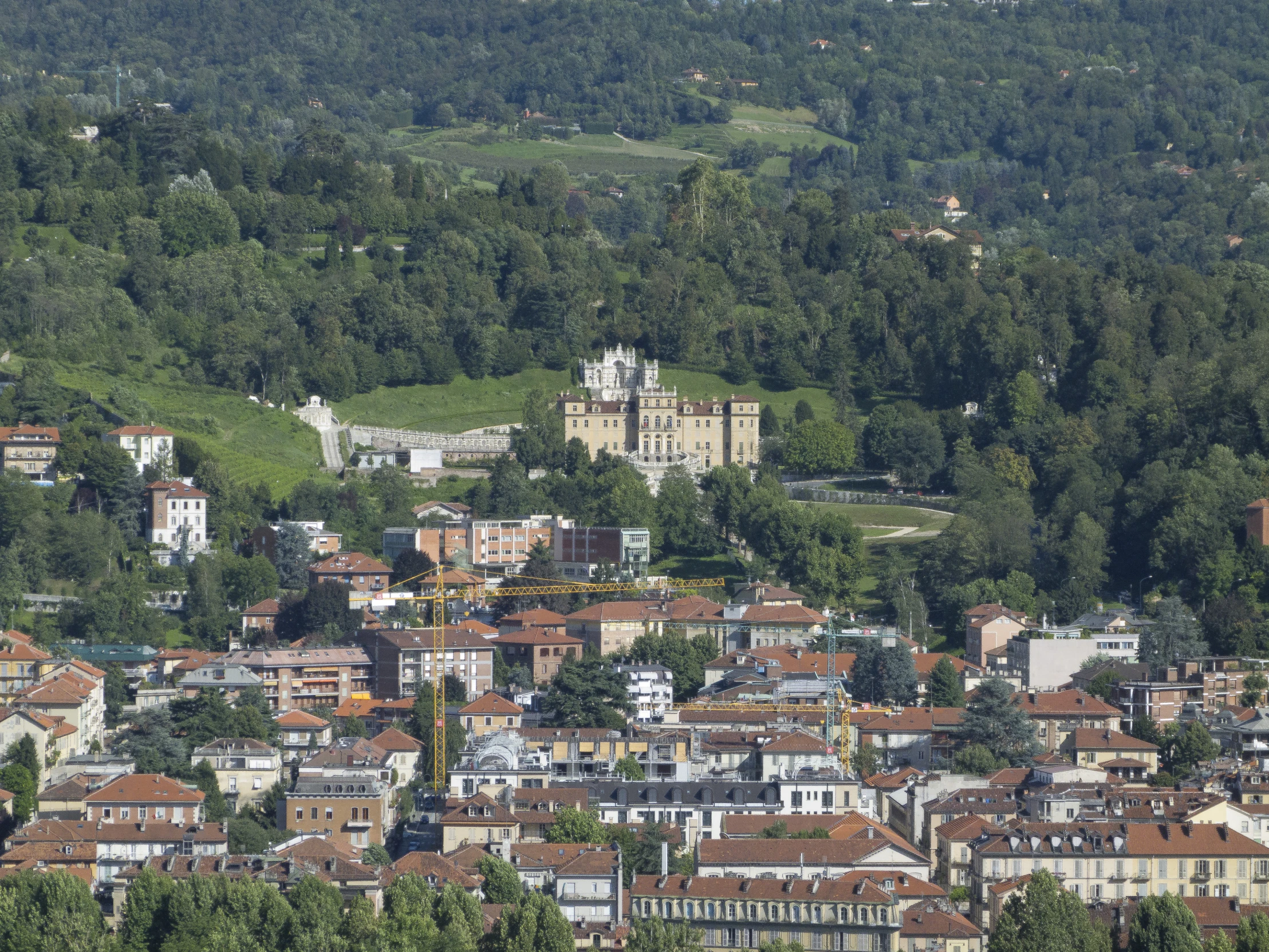 the old buildings are surrounded by trees and lush hills