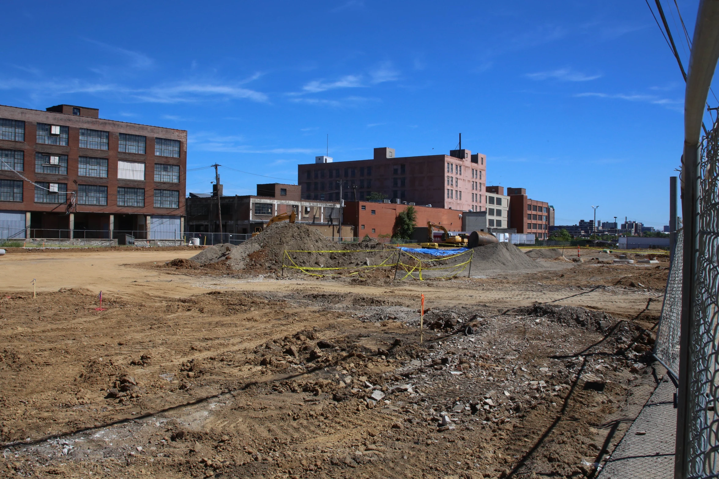 a dirt field in the middle of a city