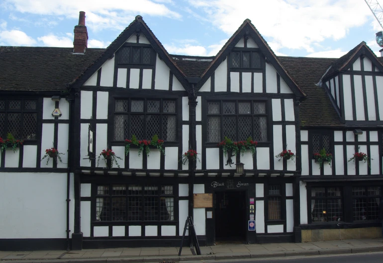 an old house with flower box in the windows