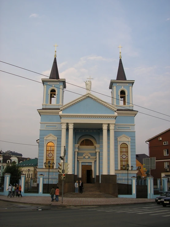 a church with blue and white paint and towers
