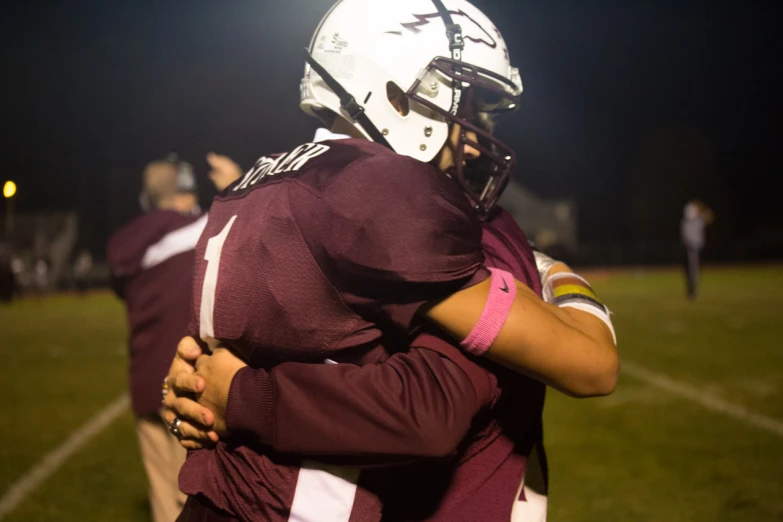 two football players hugging after a game