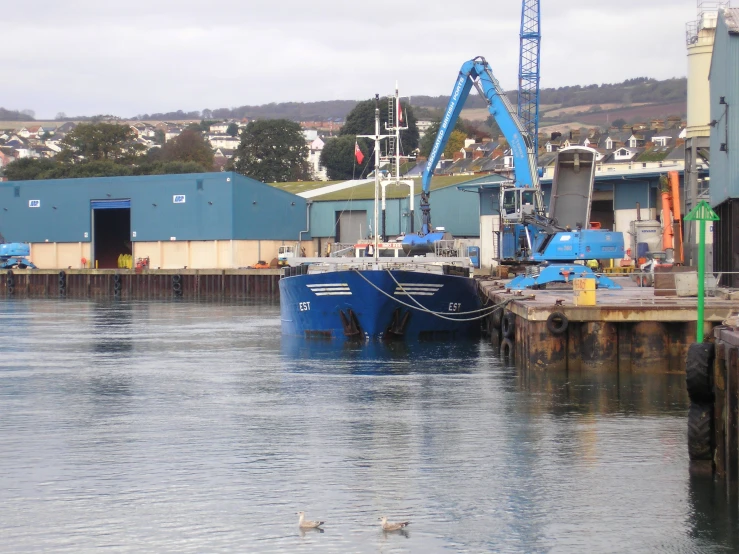 the large blue ship is in the harbor