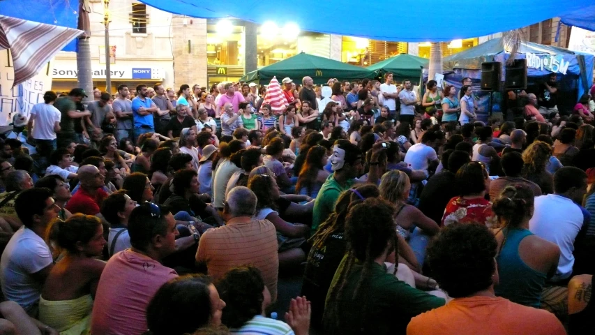 an audience watching two men on stage performing