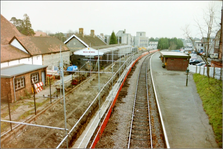 the trains are coming down the tracks beside the town