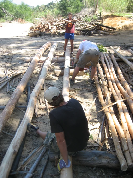 three people working together on construction in the sand