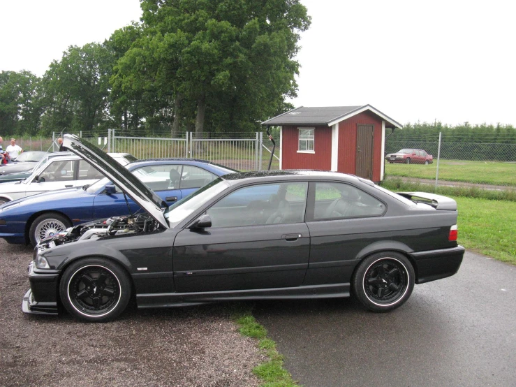 a black bmw with the hood open and the hood showing