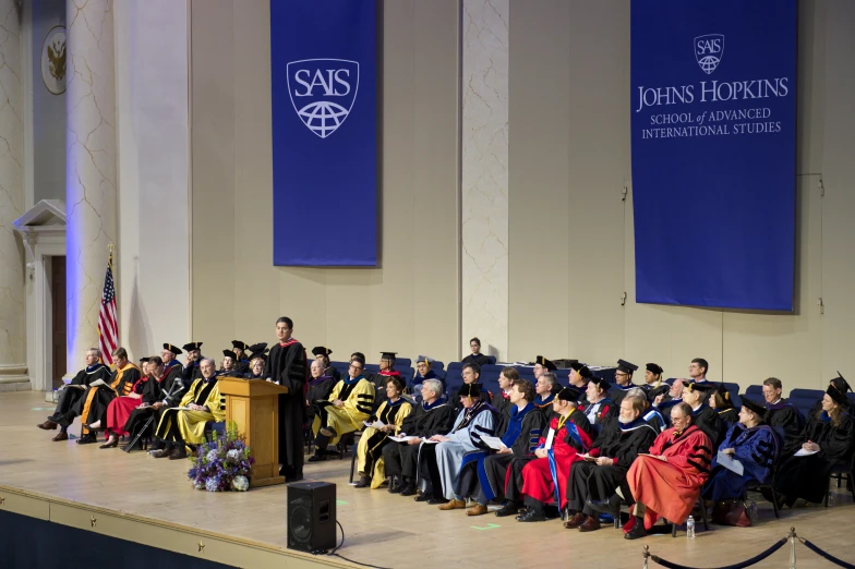 a graduation ceremony in front of people on a stage