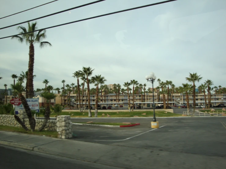 a parking lot next to a parking garage with a building in the background