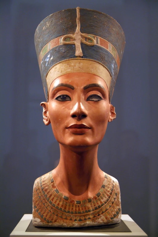 an egyptian statue in a museum setting