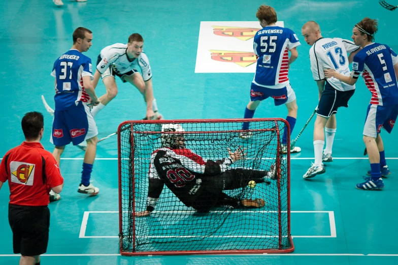 the team in the blue uniforms is trying to control the ball