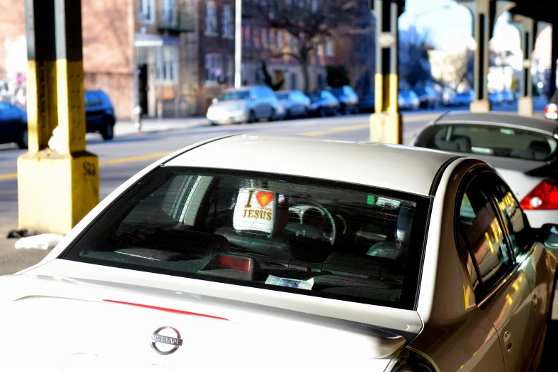 cars parked on a city street near a street sign