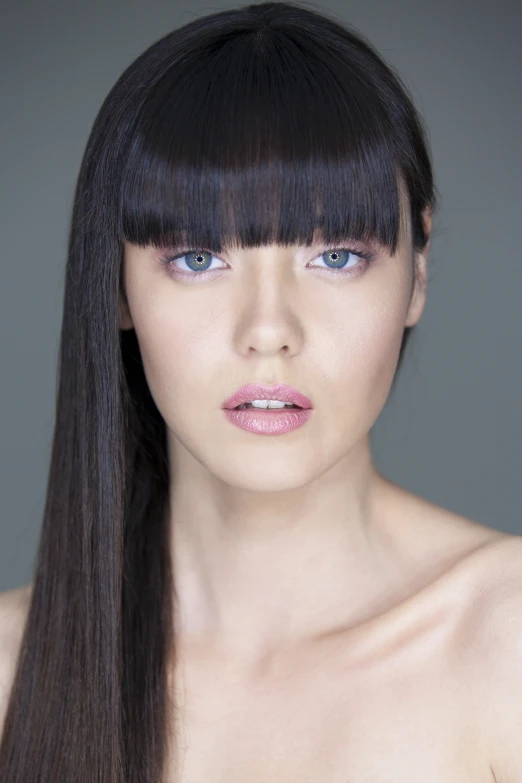 an image of woman with bangs and makeup