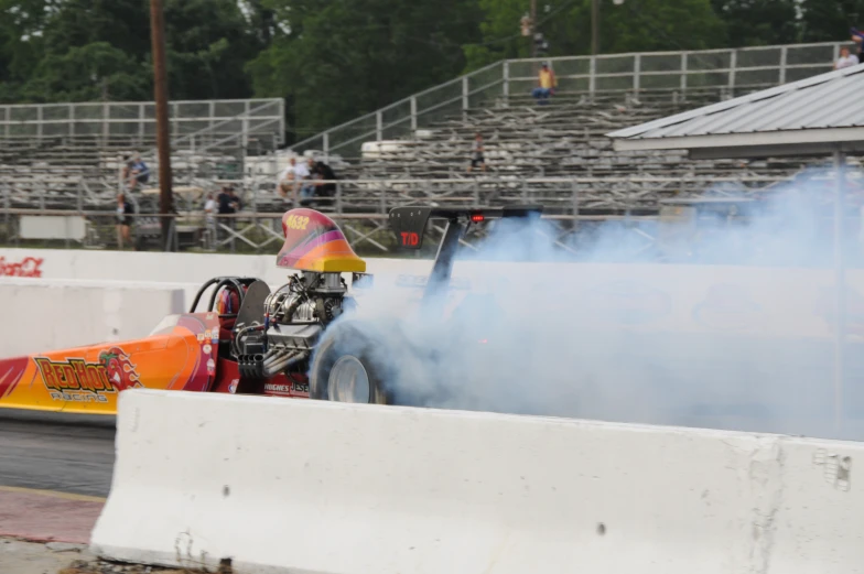 a drag car is spinning around on a track