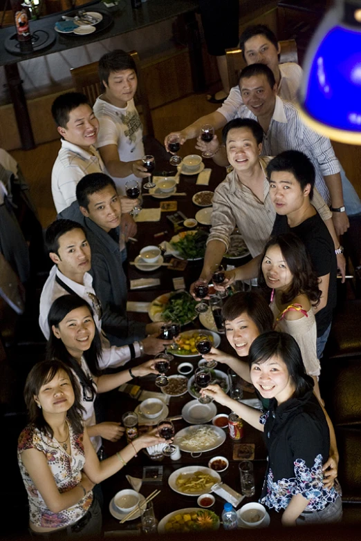 a large group of people enjoying dinner together