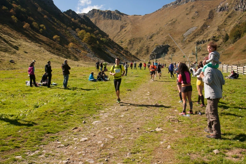 people are gathered on the grass in a field