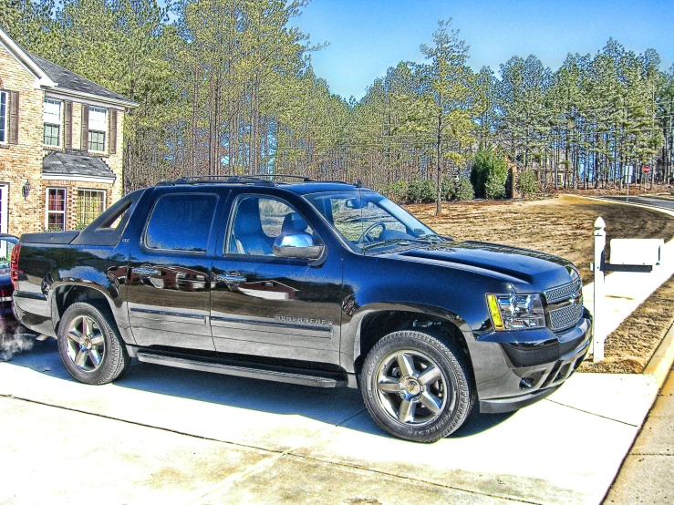 a truck parked in the driveway of a house