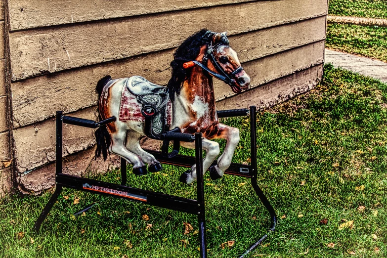 a fake horse is sitting on a chair