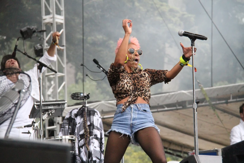 a woman in a leopard print shirt singing on stage