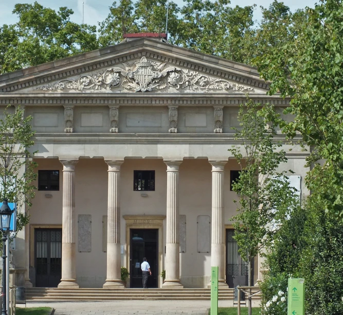 a man with an umbrella is standing outside of the building