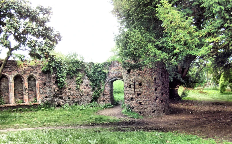 an old brick building that is surrounded by trees