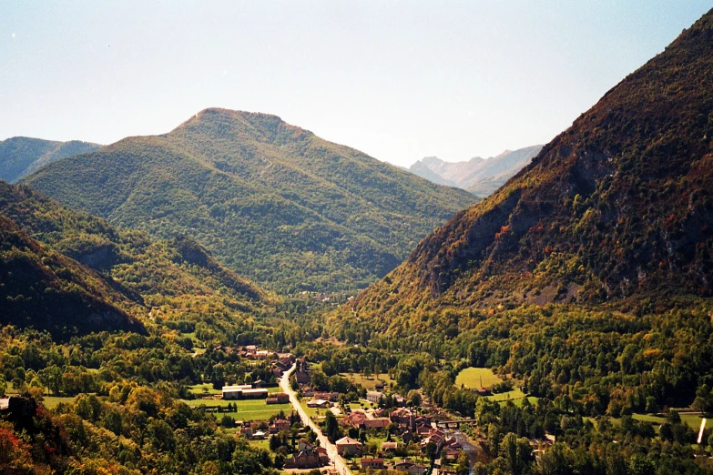 a valley that contains many trees and mountains
