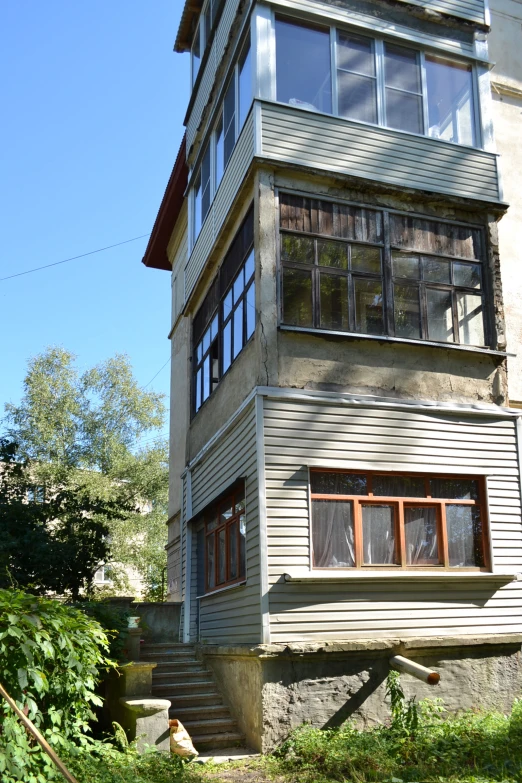 a house with many windows sitting on the side of a hill