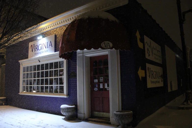 a building is on a snowy night with some snow on it