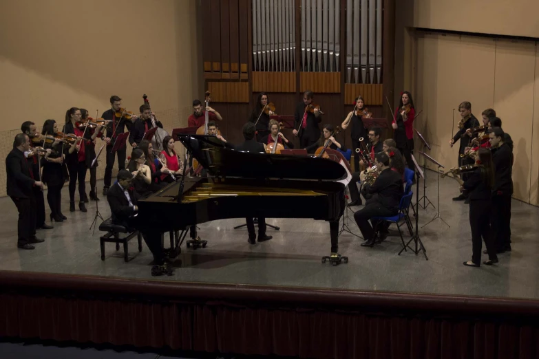 a orchestra plays and sings with a conductor behind it