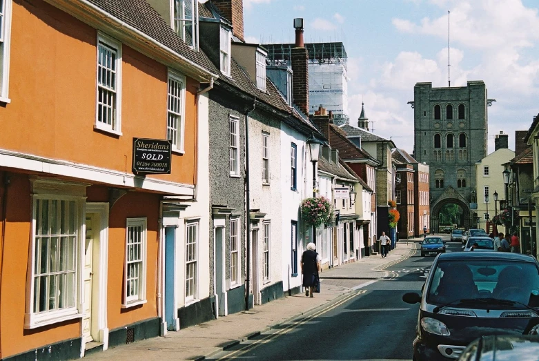 cars parked on the side of street next to buildings