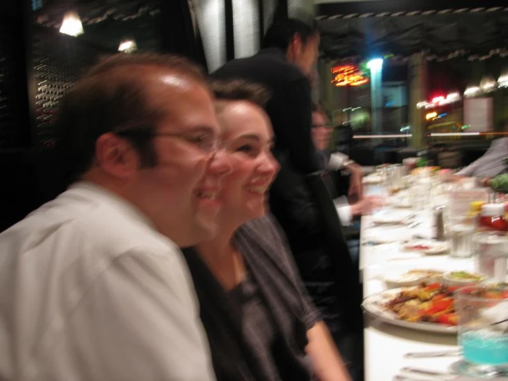 three people are enjoying a meal in the restaurant