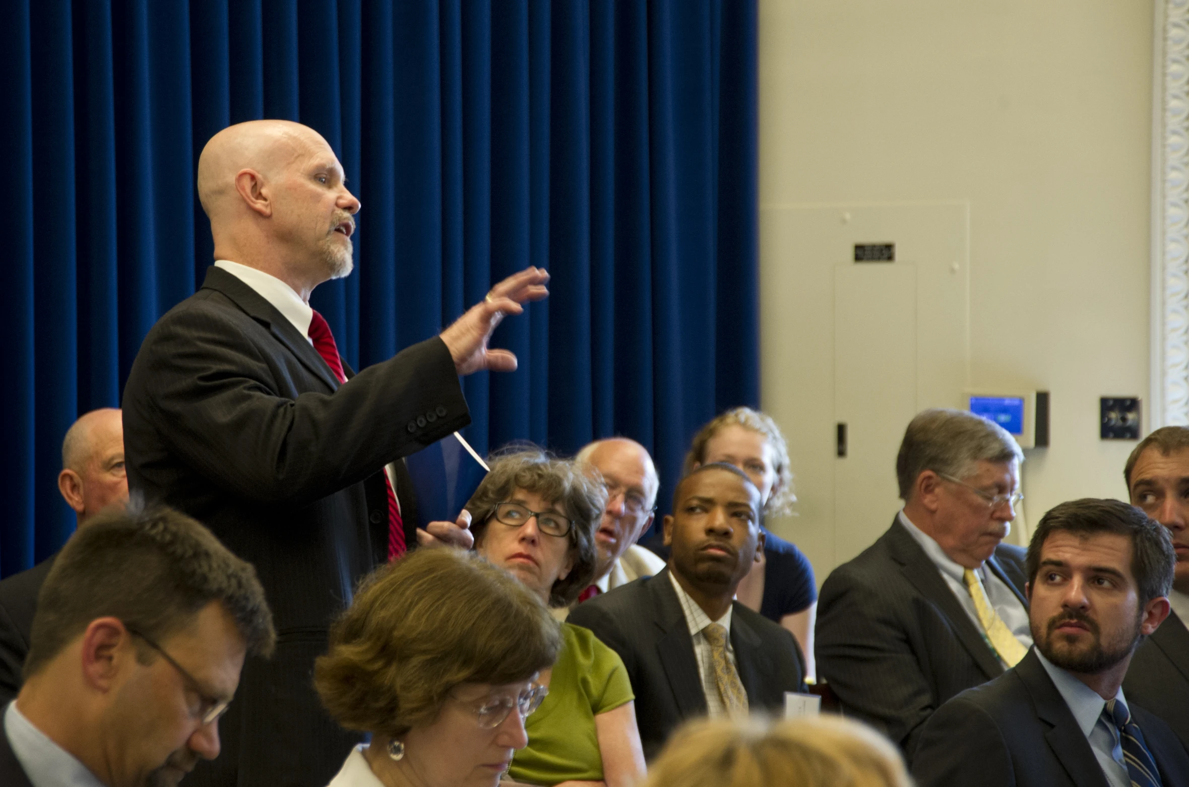 the people in the room are listening to speaker