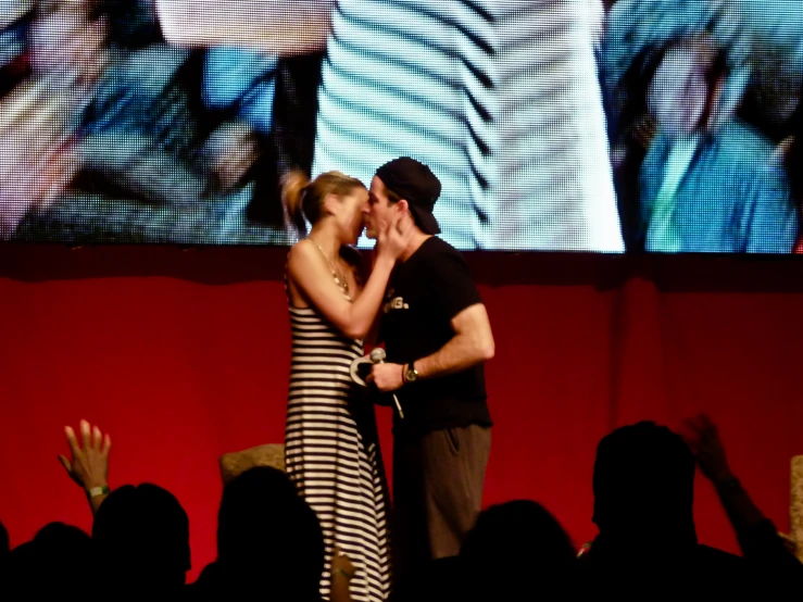 two people that are kissing on stage