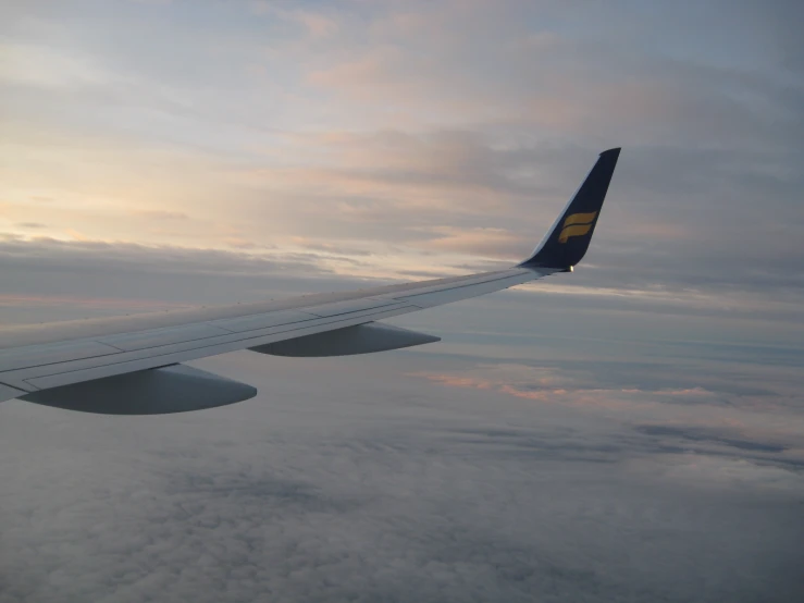 a view from the window of an airplane flying above the clouds