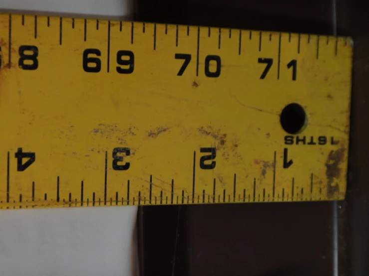 a close up of a tape measure with black numbers