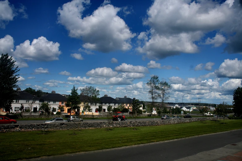 a po of the clouds and houses on a sunny day