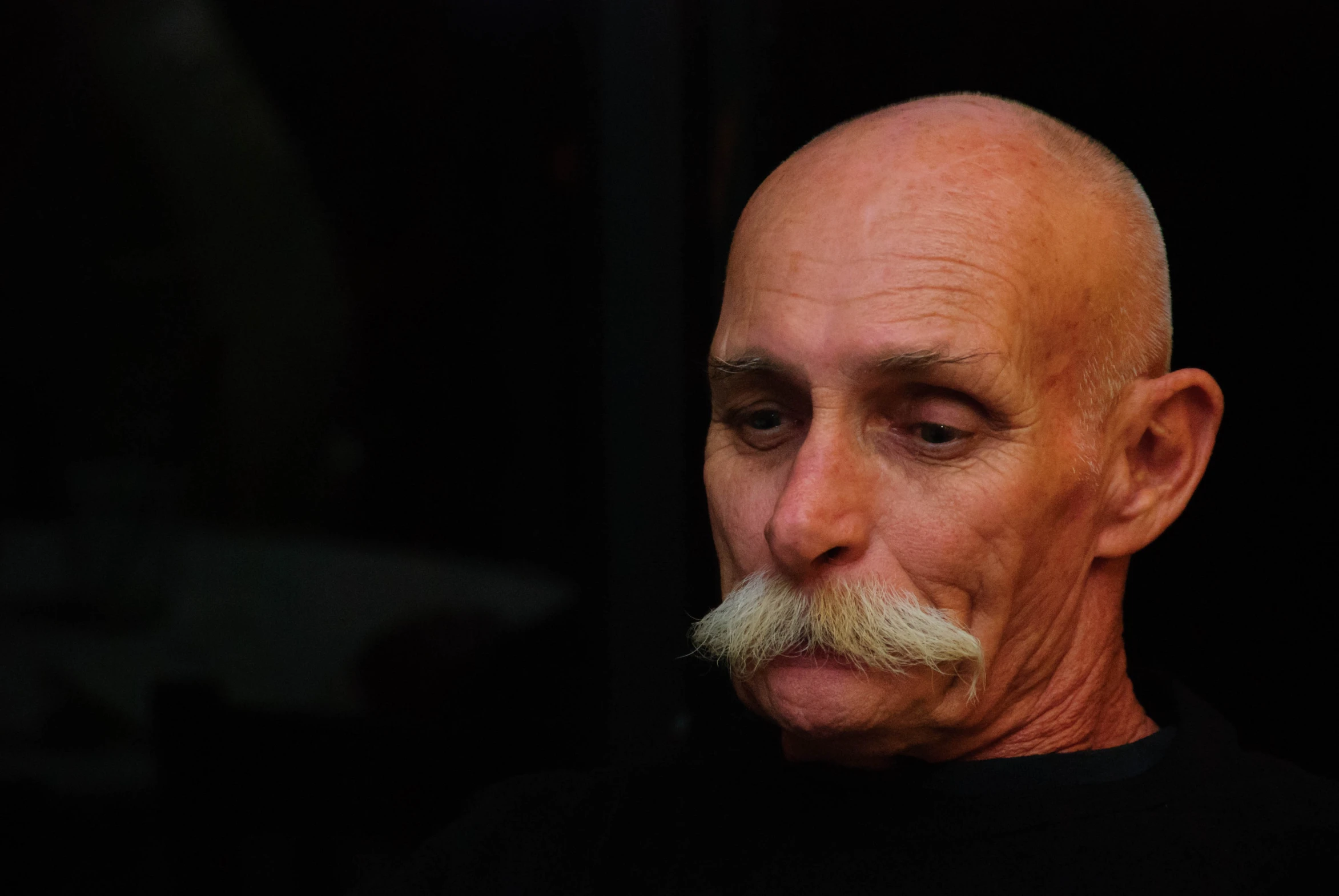 a man with a large, mustache is staring