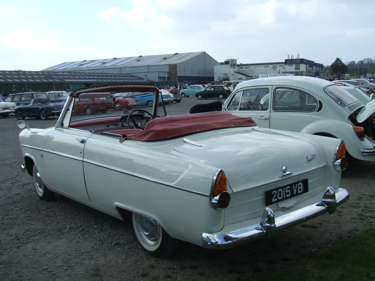 some very pretty old fashioned cars in a lot