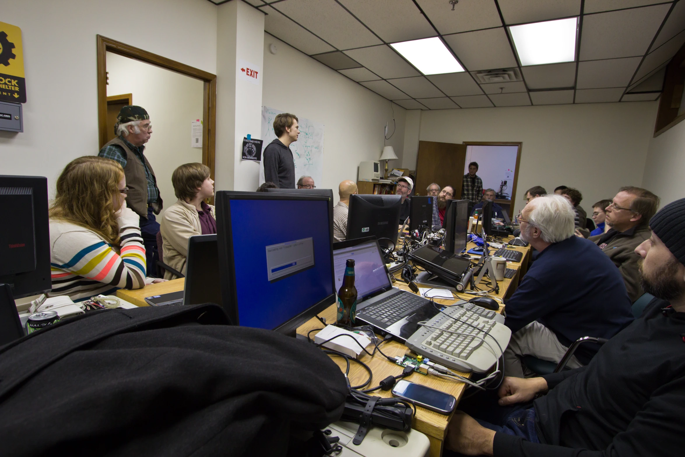 group of people looking at computers in office