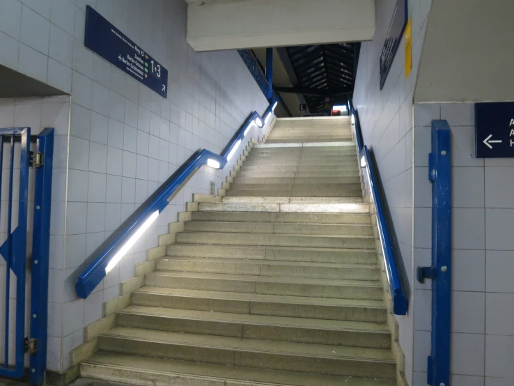 some stairs that are by a wall with lights