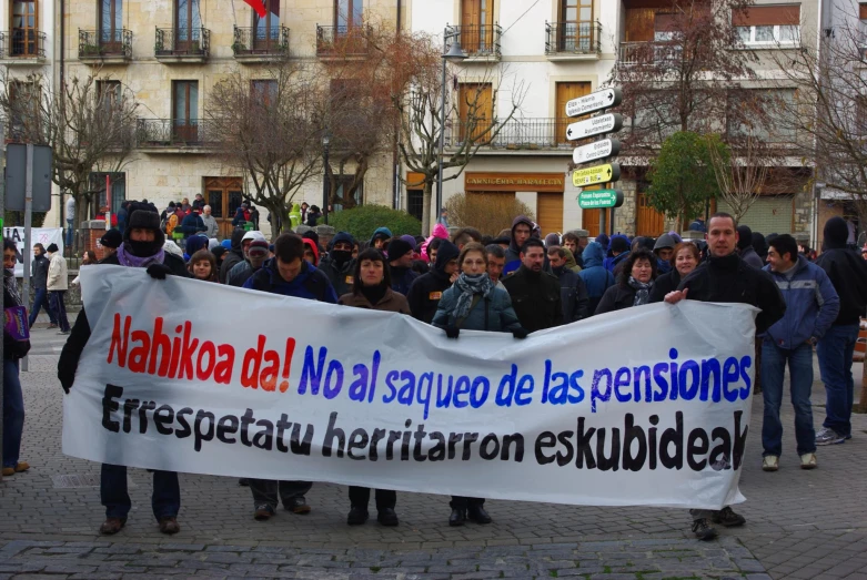 a group of people that are standing next to each other holding signs