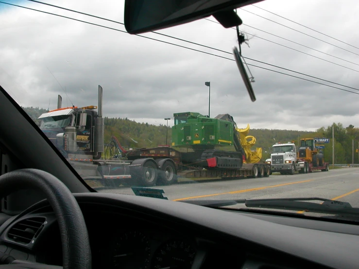 two trucks and a trailer on a highway