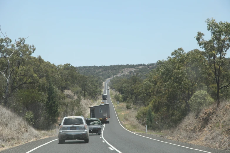 a truck and car stopped along side of a large road