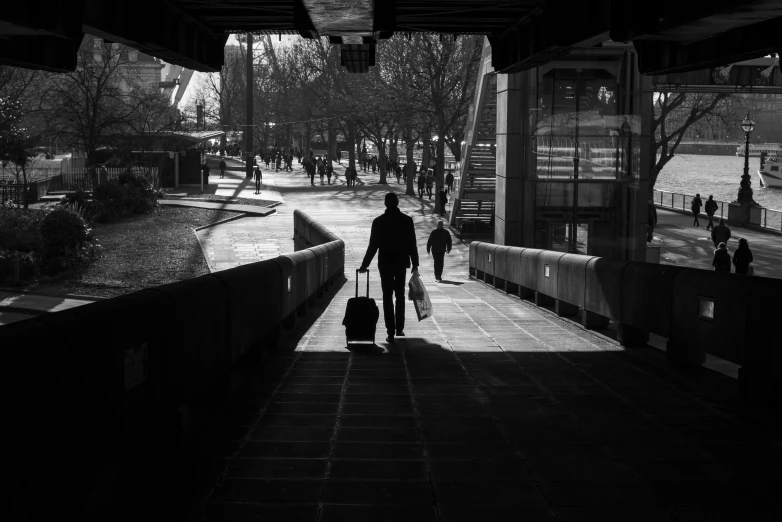 a person with a suitcase is walking down a walkway