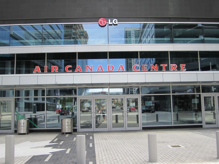 a large silver building with glass windows with the word air canadian centre above it