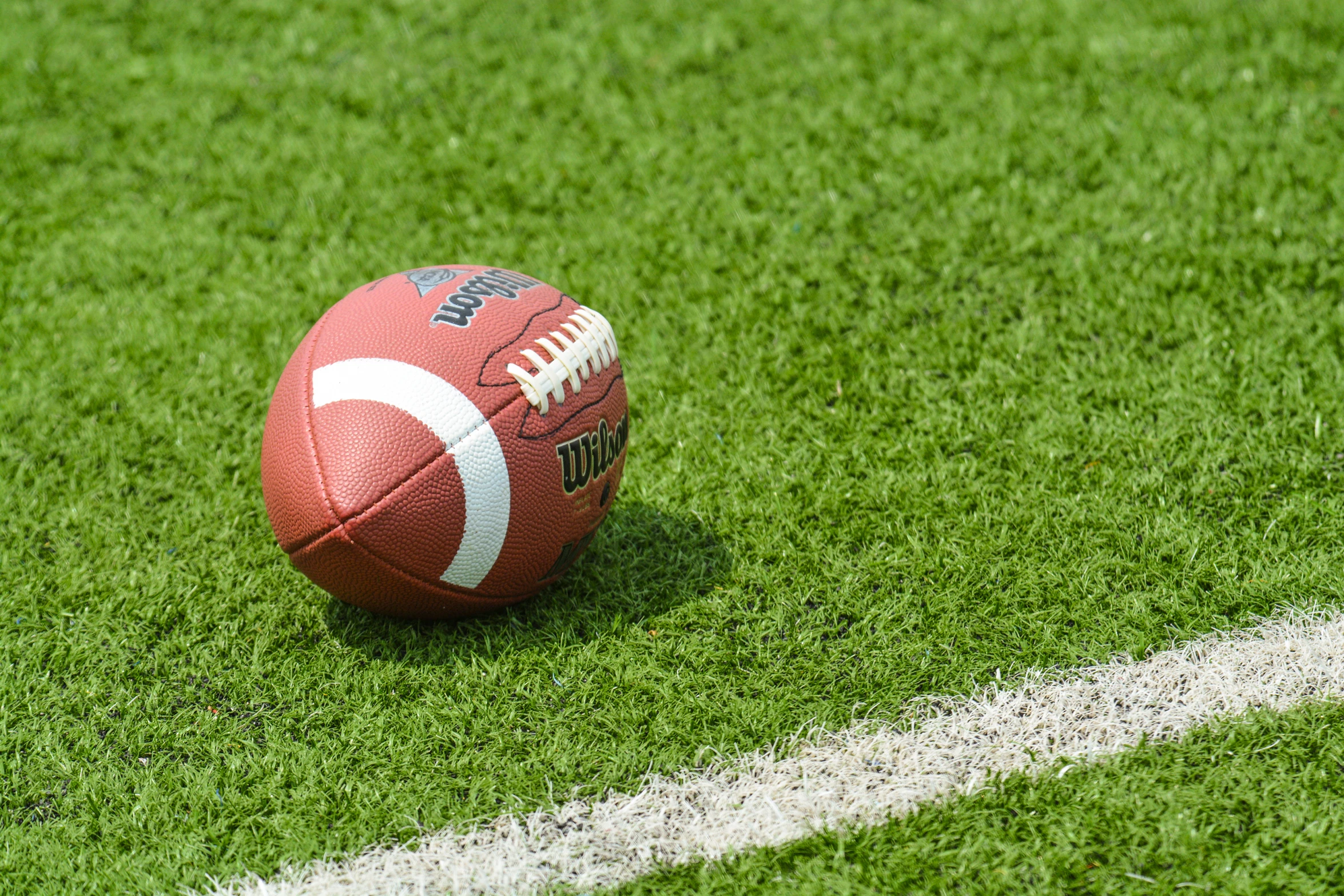 a football laying on top of green grass